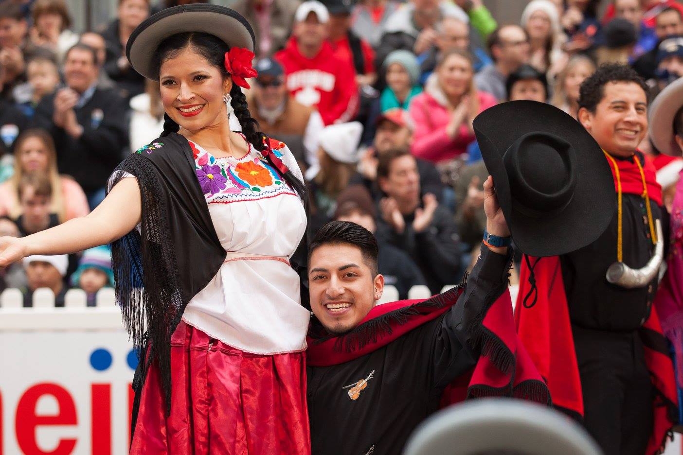 Two performers from Renacer Boliviano post for the camera after a performance in the 2015 Chicago Thanksgiving Parade