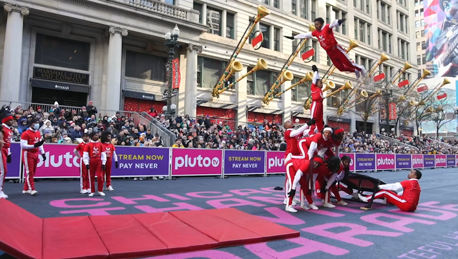 jessewhitetumblers One of hte Jesse White Tumblers flying high over his team during the Chicago Thanksgiving Parade